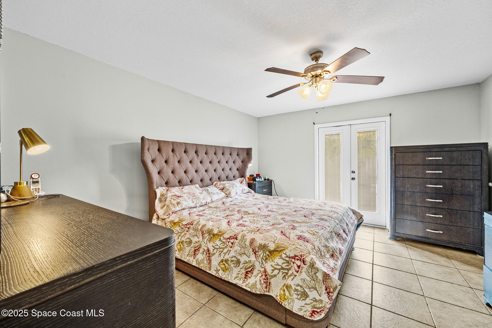 2568 Longwood Boulevard Melbourne, FL 32934 - Photo 19 of 42 a bedroom with a bed and cabinets