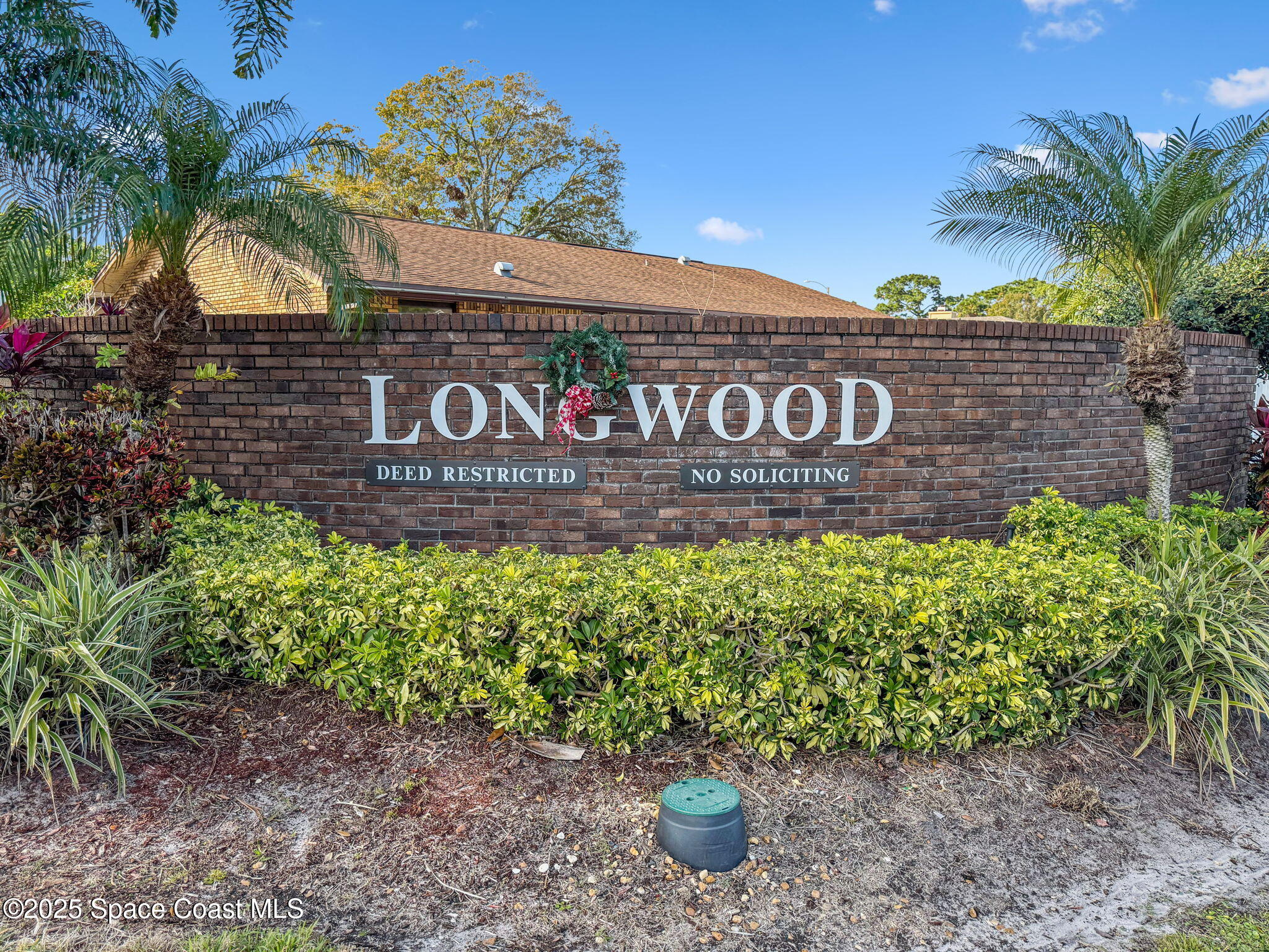 2568 Longwood Boulevard Melbourne, FL 32934 - Photo 2 of 42 a street sign that is sitting in front of flowers