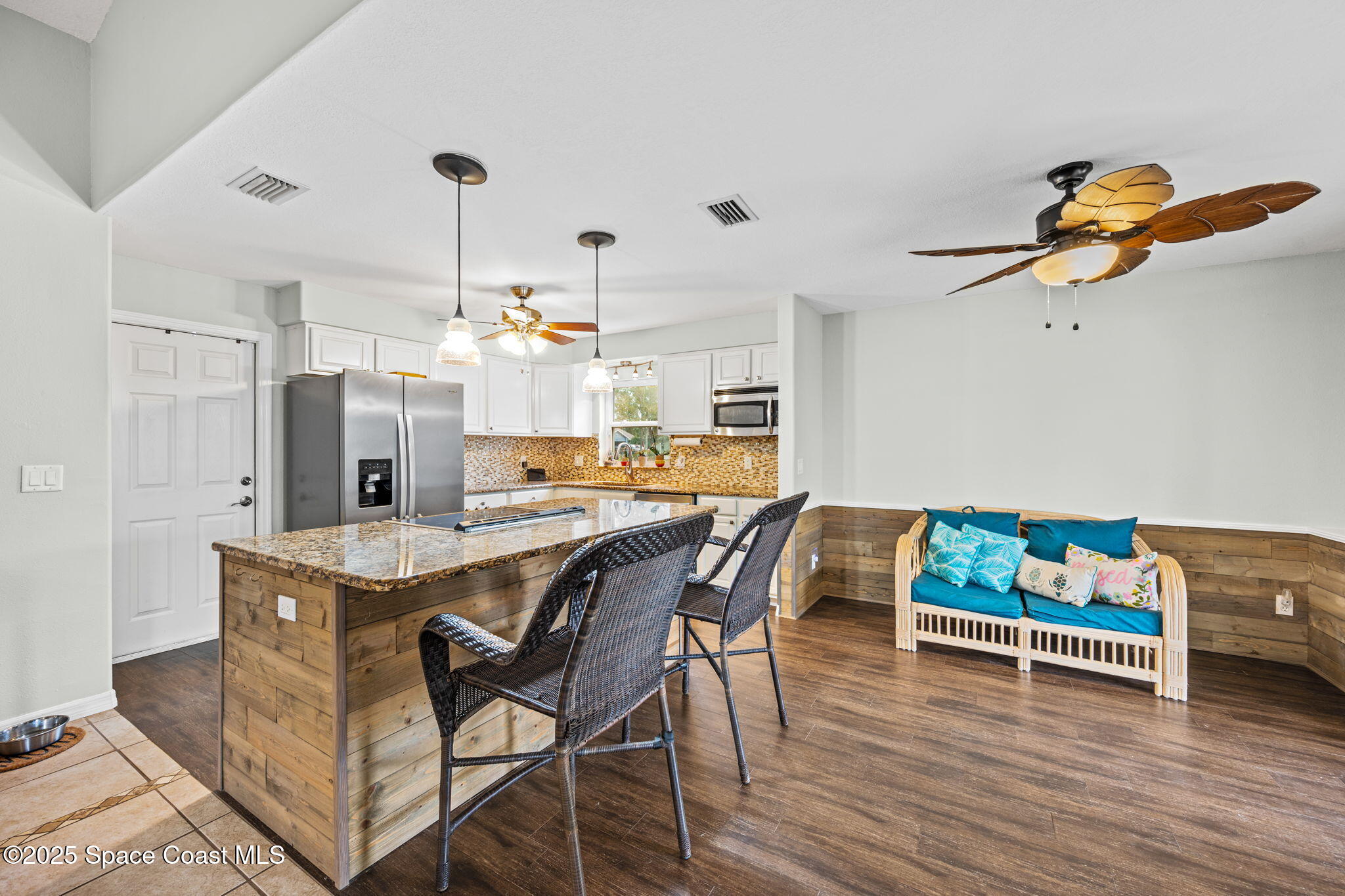 2568 Longwood Boulevard Melbourne, FL 32934 - Photo 25 of 42 a dining room with furniture and wooden floor