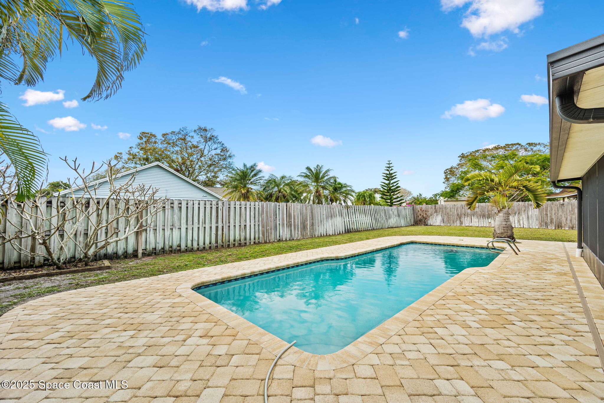 2568 Longwood Boulevard Melbourne, FL 32934 - Photo 36 of 42 a view of a swimming pool with a lounge chairs