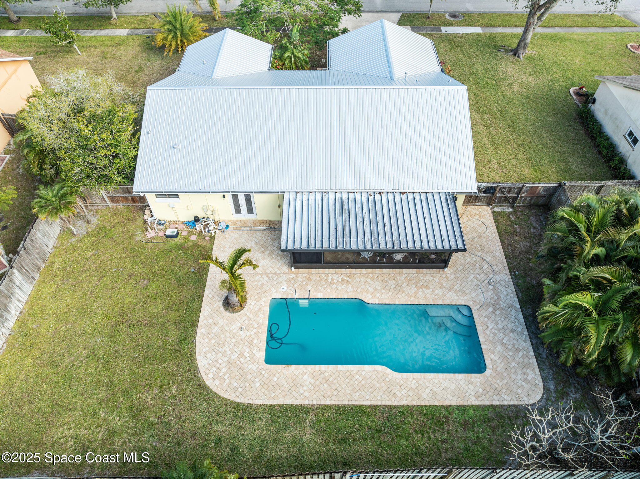 2568 Longwood Boulevard Melbourne, FL 32934 - Photo 4 of 42 an aerial view of a house with swimming pool and outdoor seating