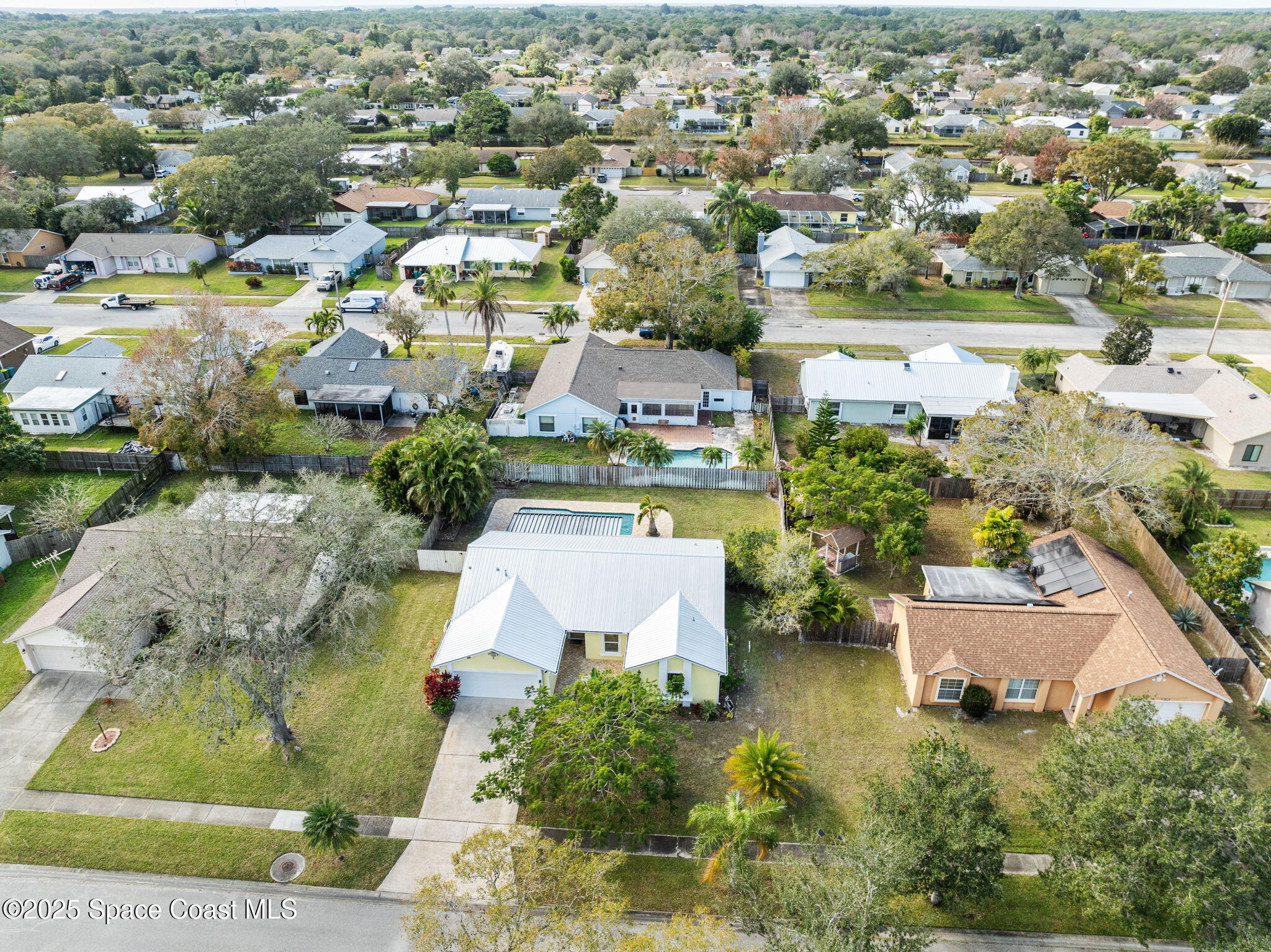 2568 Longwood Boulevard Melbourne, FL 32934 - Photo 5 of 42 an aerial view of residential houses with outdoor space and parking