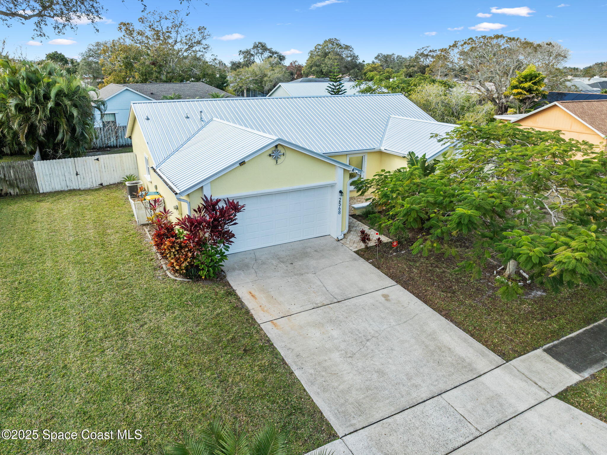 2568 Longwood Boulevard Melbourne, FL 32934 - Photo 6 of 42 a view of a house with a yard and potted plants