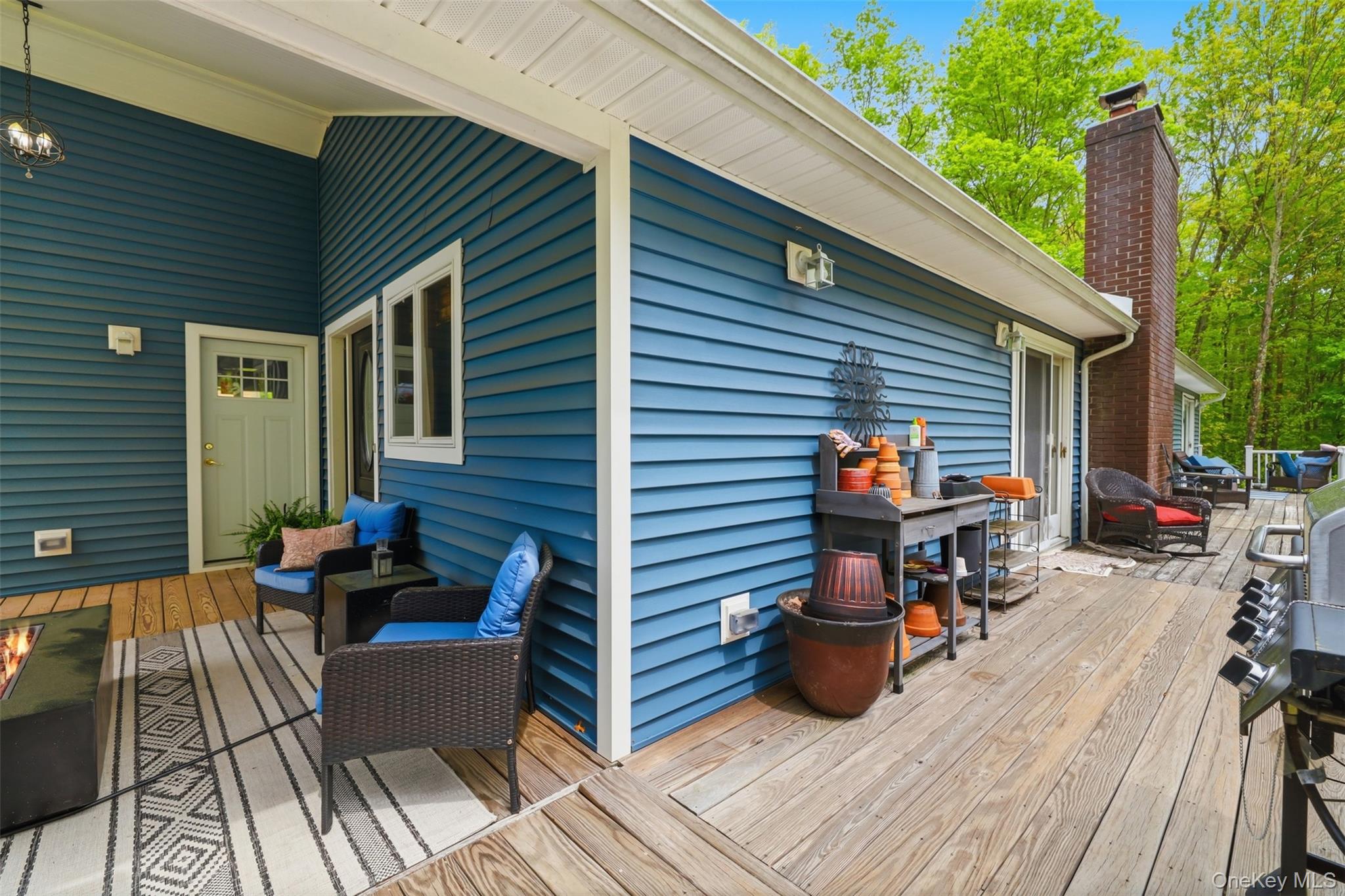 128 Sawmill Road Red Hook, NY 12571 - Photo 32 of 40 a view of a patio with table and chairs potted plants with wooden floor and fence