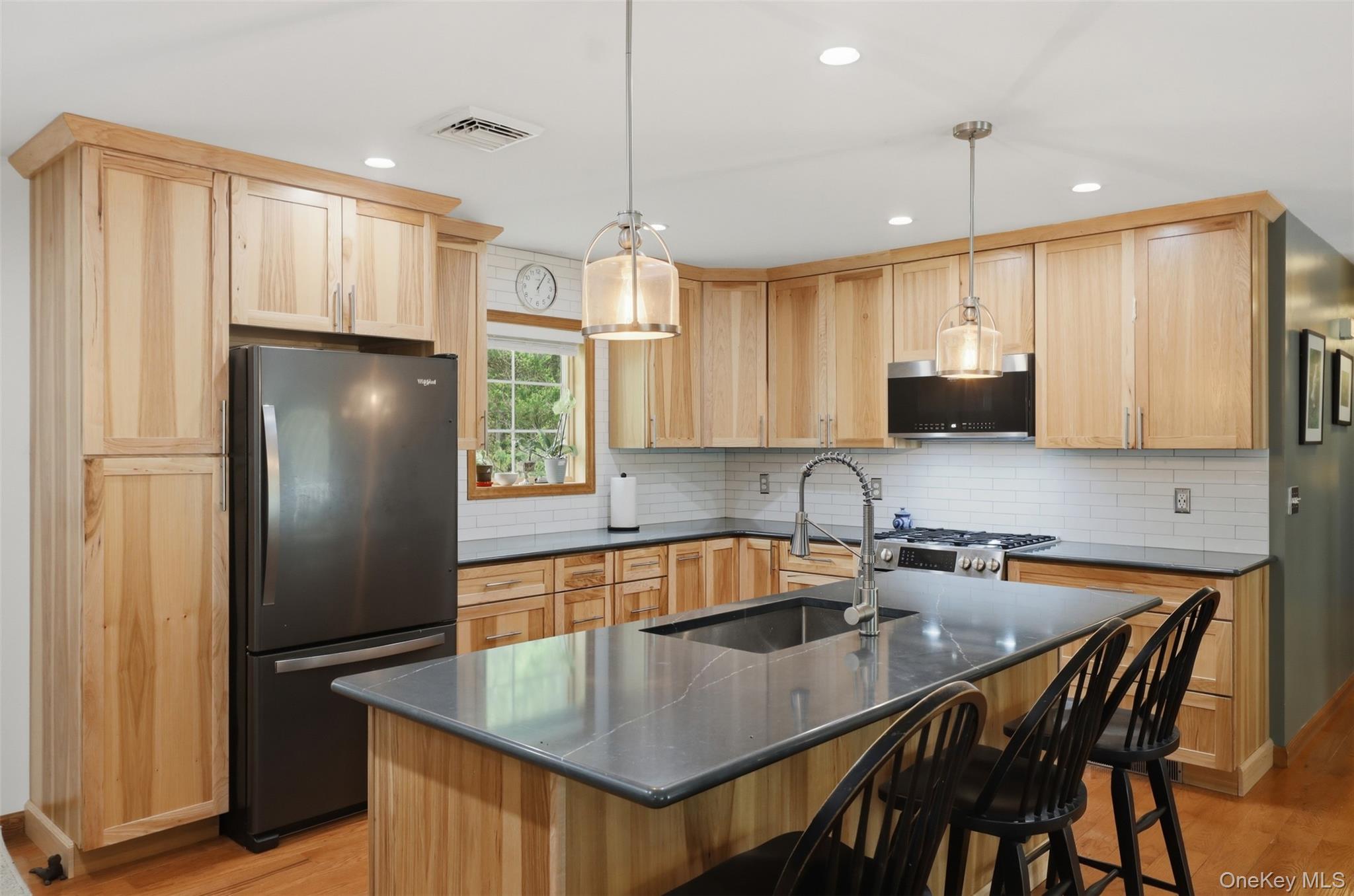 128 Sawmill Road Red Hook, NY 12571 - Photo 9 of 40 a kitchen with stainless steel appliances granite countertop a refrigerator a sink a center island and furniture