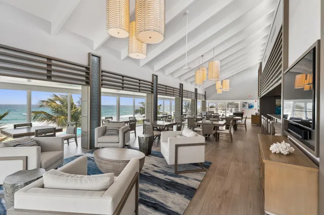 a living room with fireplace furniture and a large window