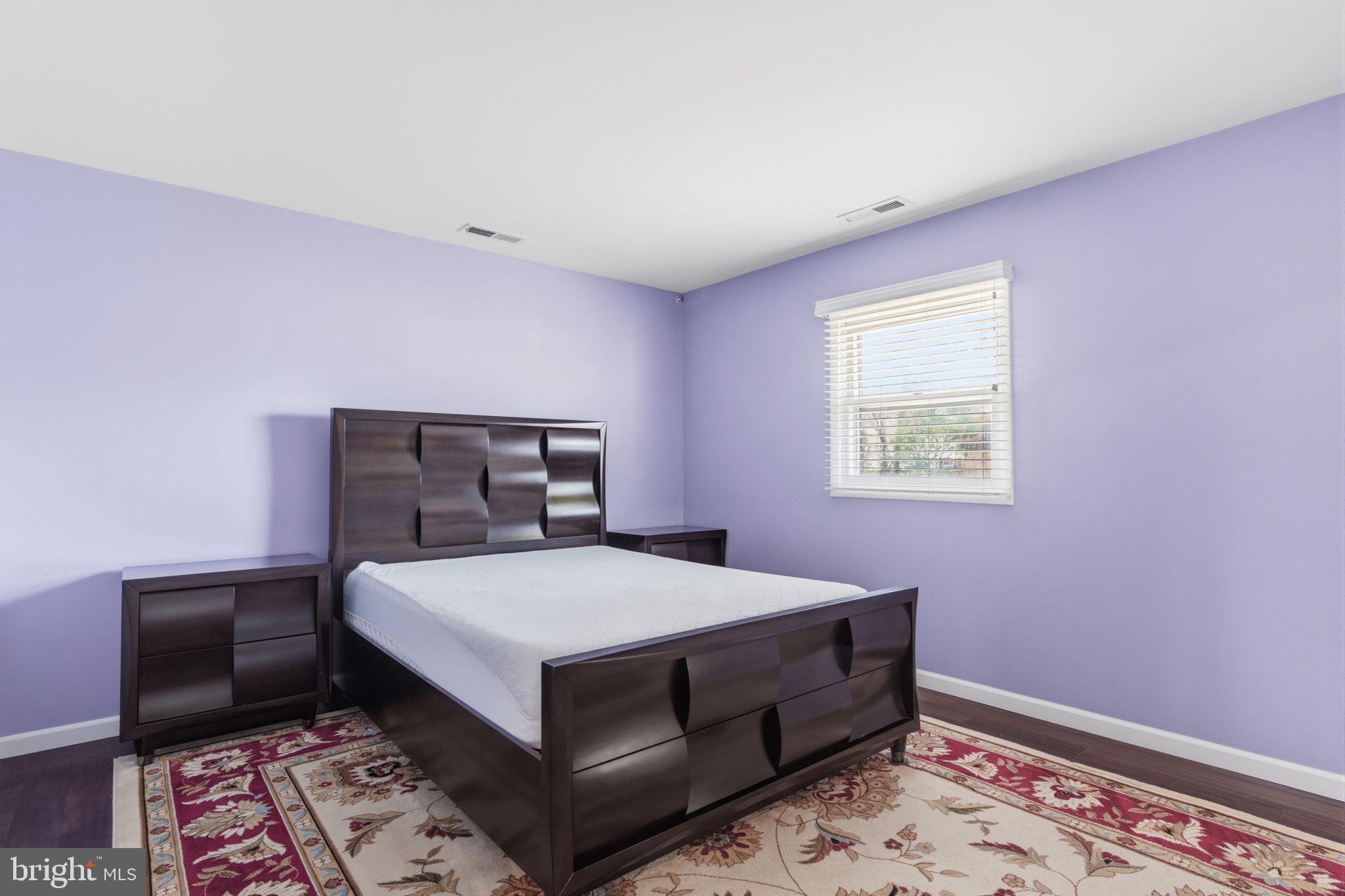 802 Eldridge Road Fairless Hills, PA 19030 - Photo 22 of 32 a bedroom with a bed and a lamp on dresser