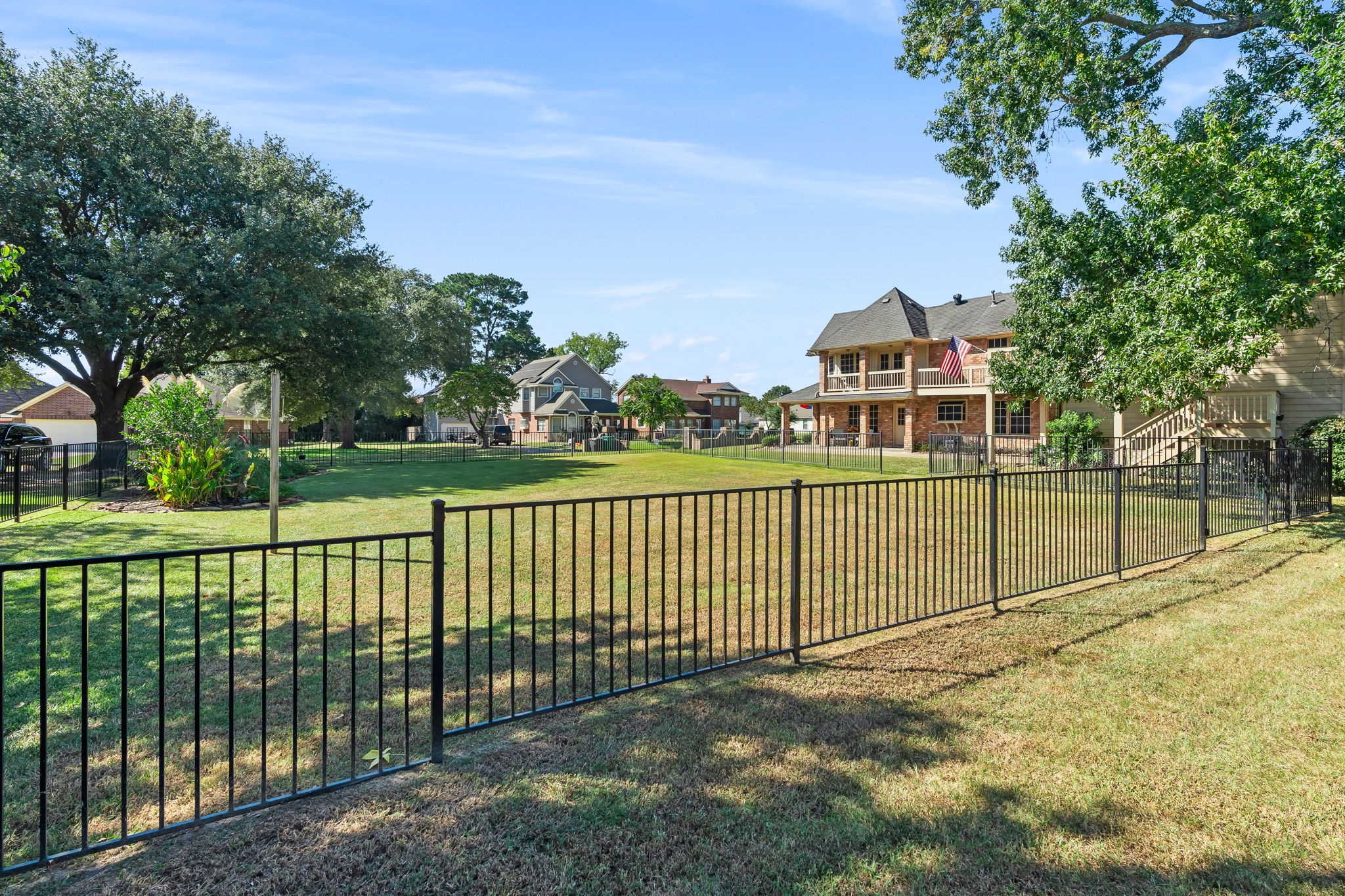6971 Breezy Point Willis, TX 77318 - Photo 38 of 49 Looking from back of the adjacent lot you can see the outside staircase to the quarters. There is also a door from the game room up on the balcony that leads to the quarters as well.