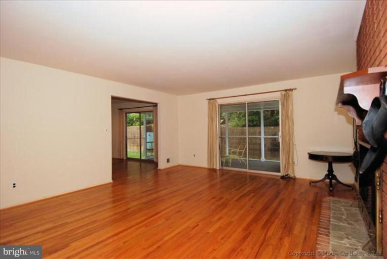 12809 Broadmore Road Silver Spring, MD 20904 - Photo 4 of 19 an empty room with wooden floor and windows