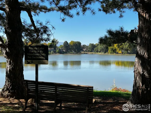 a view of a lake with sitting area and garden