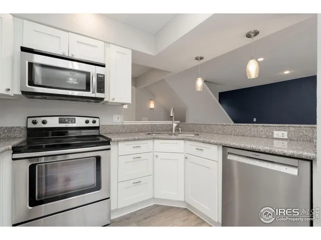 a kitchen with stainless steel appliances granite countertop a stove microwave and sink