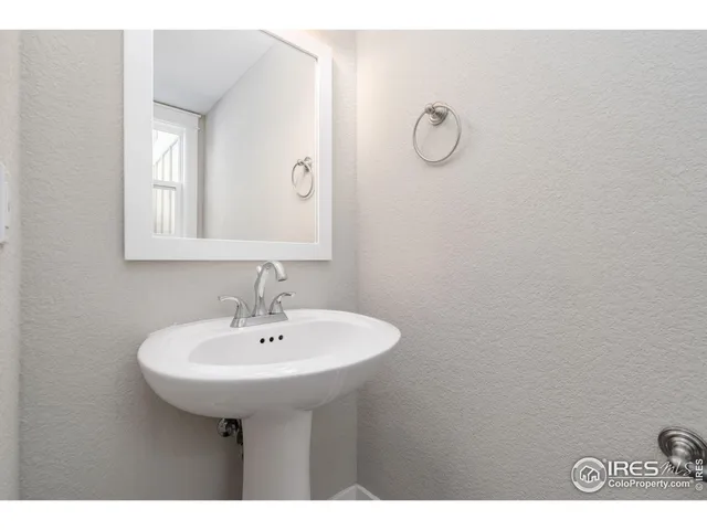 a bathroom with a sink a mirror and shower