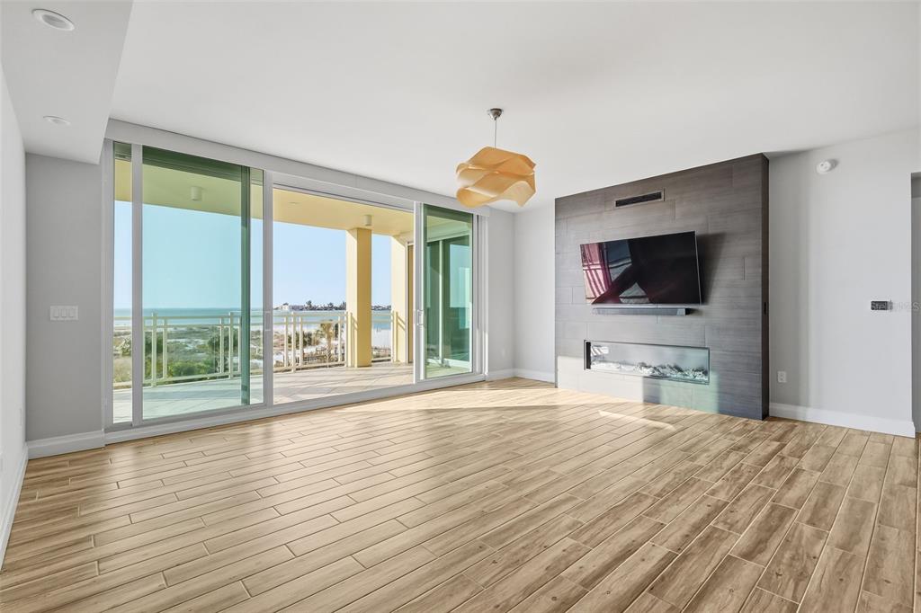 800 Collany Road, Unit 302 St. Petersburg, FL 33715 - Photo 21 of 66 a view of a livingroom with wooden floor and a flat screen tv