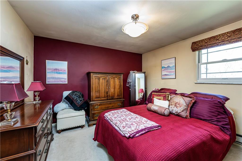 2037 Ridge Road Jeannette, PA 15644 - Photo 17 of 24 a bedroom with a bed and a chandelier