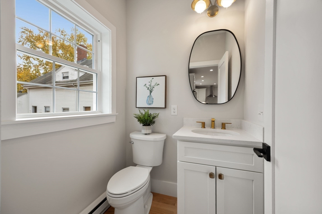 3-5 Victoria Road, Unit 3 Arlington, MA 02474 - Photo 12 of 36 a bathroom with a toilet a sink and a mirror