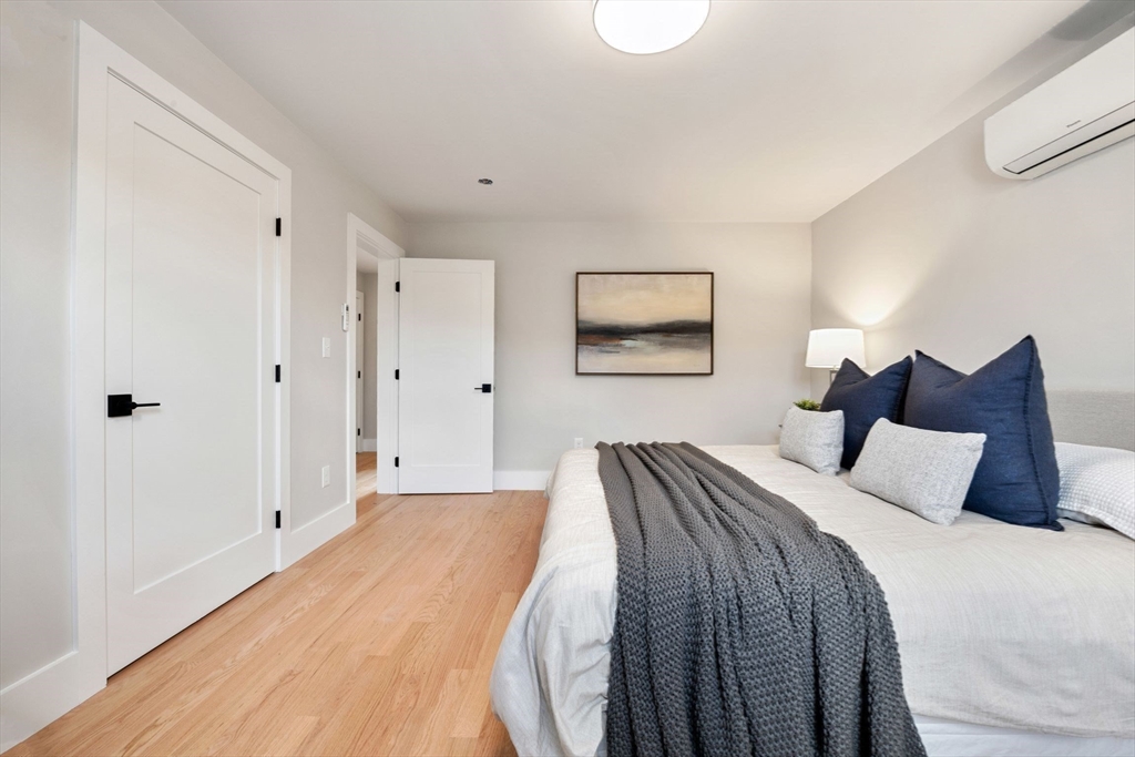 3-5 Victoria Road, Unit 3 Arlington, MA 02474 - Photo 14 of 36 a bedroom with a bed and a painting on the wall