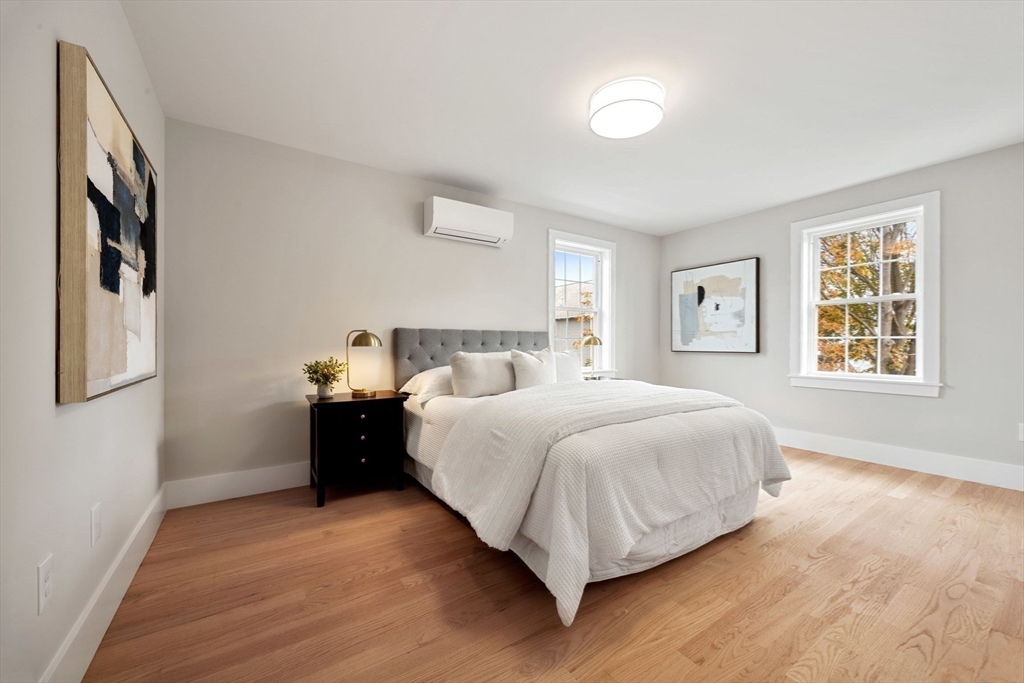 3-5 Victoria Road, Unit 3 Arlington, MA 02474 - Photo 17 of 36 a bedroom with a bed and painting on the wall