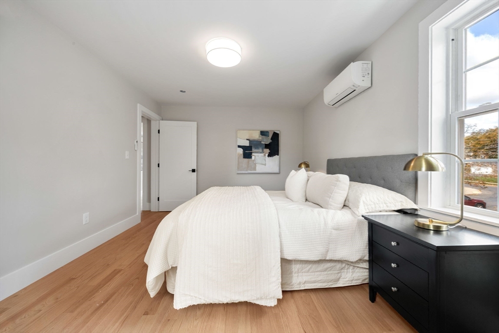 3-5 Victoria Road, Unit 3 Arlington, MA 02474 - Photo 18 of 36 a bedroom with a bed and wooden floor