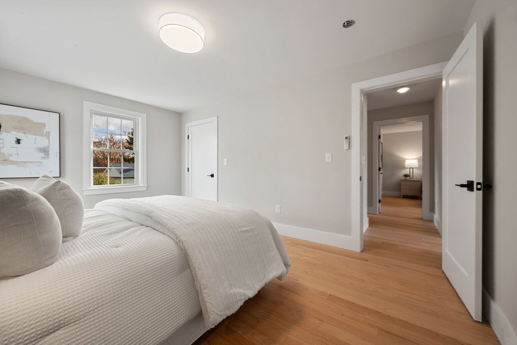 3-5 Victoria Road, Unit 3 Arlington, MA 02474 - Photo 19 of 36 a spacious bedroom with a bed and a large window