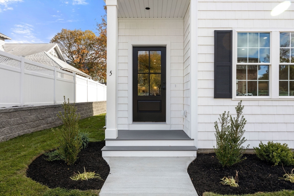 3-5 Victoria Road, Unit 3 Arlington, MA 02474 - Photo 2 of 36 a front view of a house with a yard