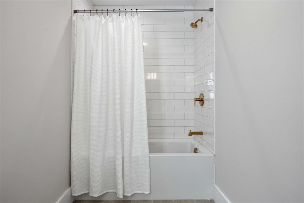 3-5 Victoria Road, Unit 3 Arlington, MA 02474 - Photo 22 of 36 a bathroom with a bathtub and shower