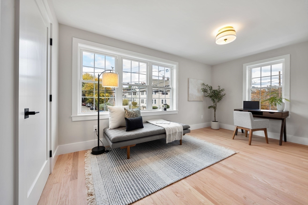 3-5 Victoria Road, Unit 3 Arlington, MA 02474 - Photo 23 of 36 a living room with furniture and a wooden floor