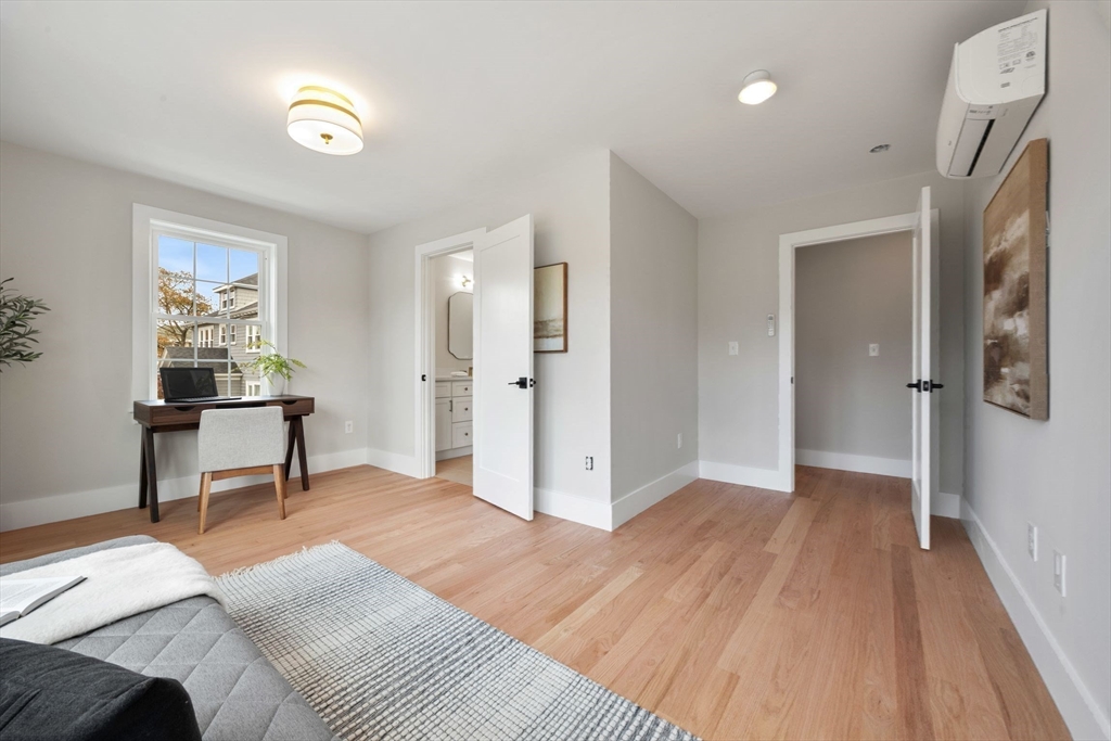 3-5 Victoria Road, Unit 3 Arlington, MA 02474 - Photo 24 of 36 a view of a bedroom with wooden floor and furniture