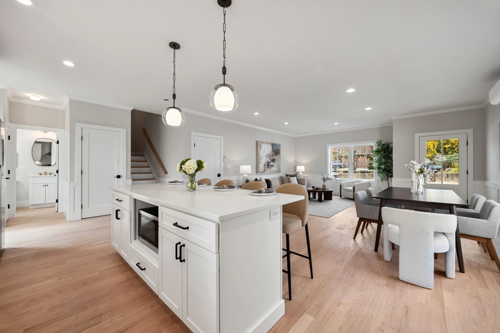 3-5 Victoria Road, Unit 3 Arlington, MA 02474 - Photo 3 of 36 a large white kitchen with lots of counter space a sink appliances and wooden floor