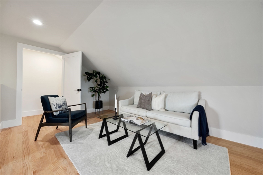 3-5 Victoria Road, Unit 3 Arlington, MA 02474 - Photo 33 of 36 a living room with furniture and a potted plant