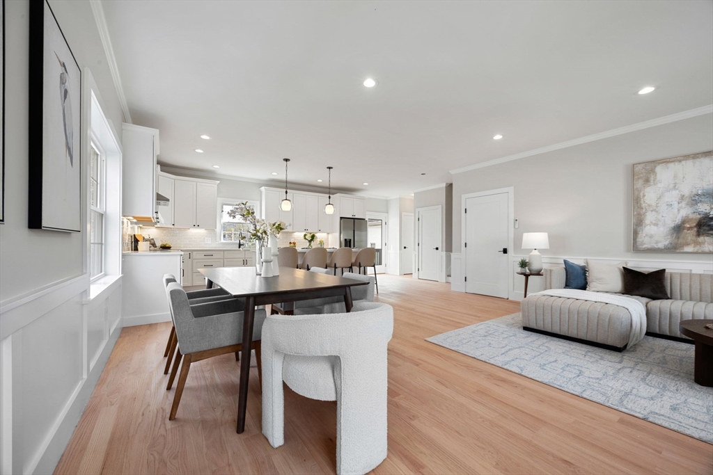 3-5 Victoria Road, Unit 3 Arlington, MA 02474 - Photo 6 of 36 a living room with furniture and a dining table with wooden floor