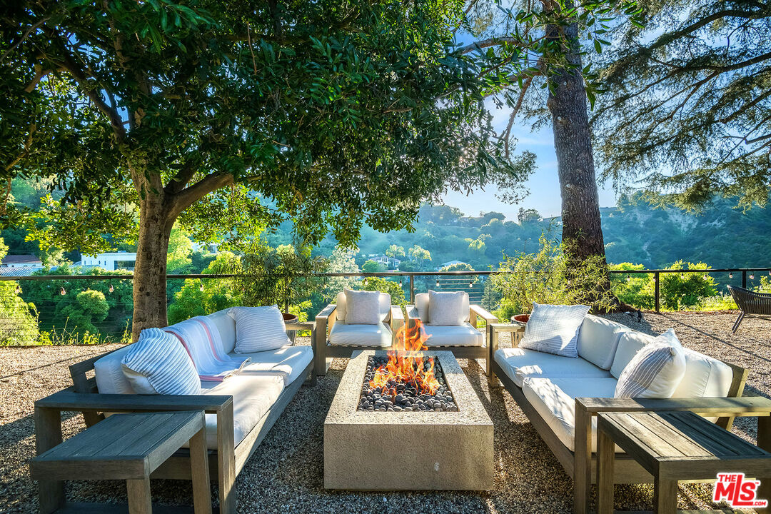 an outdoor sitting area with furniture and garden view
