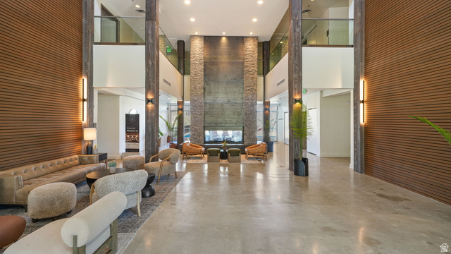 1364 Still Water Drive, Unit R2012 Heber City, UT 84032 - Photo 24 of 30 Open-concept communal lounge with high ceilings, concrete flooring, and a large fireplace feature wall