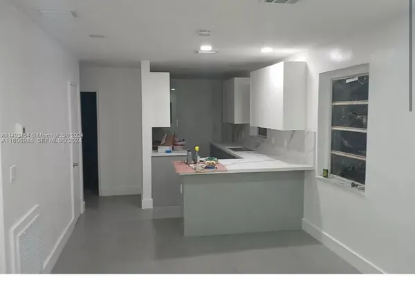 a kitchen with kitchen island a sink stainless steel appliances and cabinets