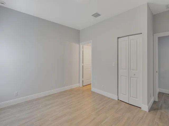 a view of an empty room and wooden floor