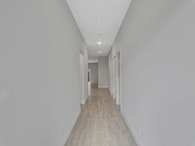 a view of a hallway with wooden floor