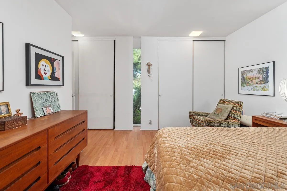 4875 Academy Street San Diego, CA 92109 - Photo 15 of 33 a bed room with a bed and a dresser