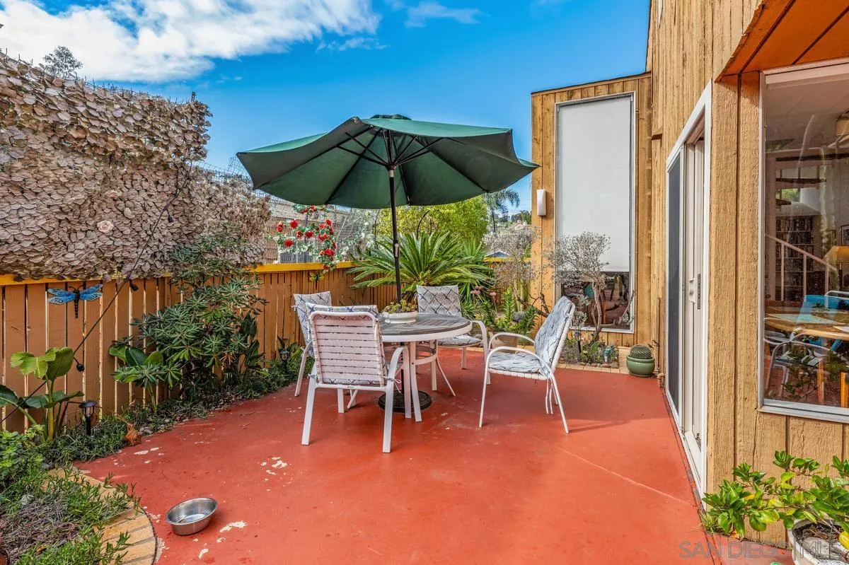 4875 Academy Street San Diego, CA 92109 - Photo 23 of 33 a patio with a patio table and chairs