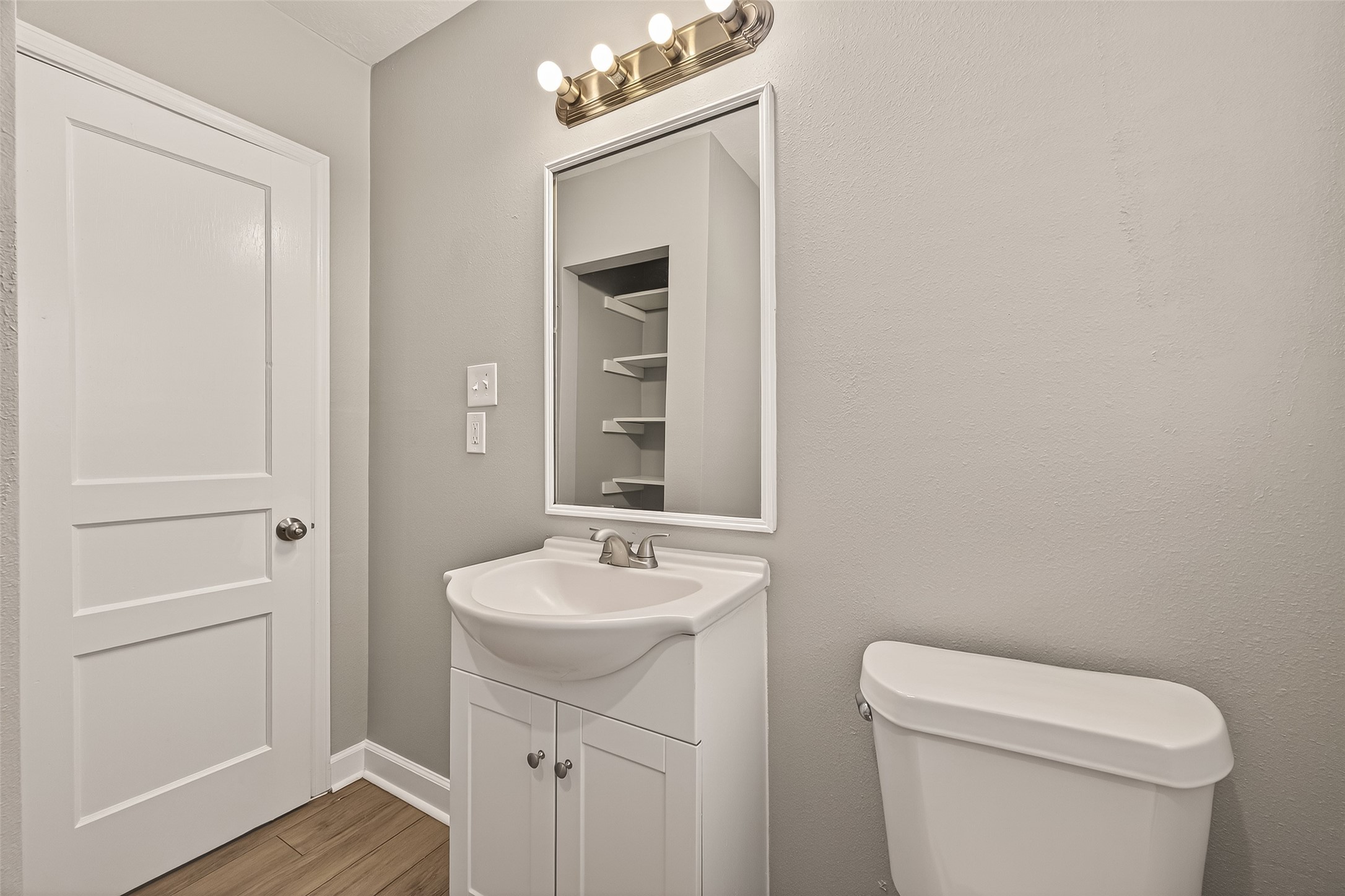 6615 Kernel Street Houston, TX 77087 - Photo 15 of 20 a bathroom with a toilet a sink a vanity and mirror