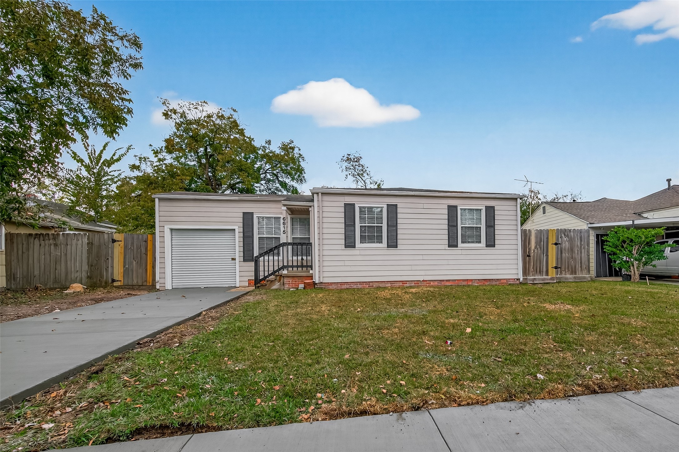 6615 Kernel Street Houston, TX 77087 - Photo 19 of 20 a front view of house with yard and trees in the background