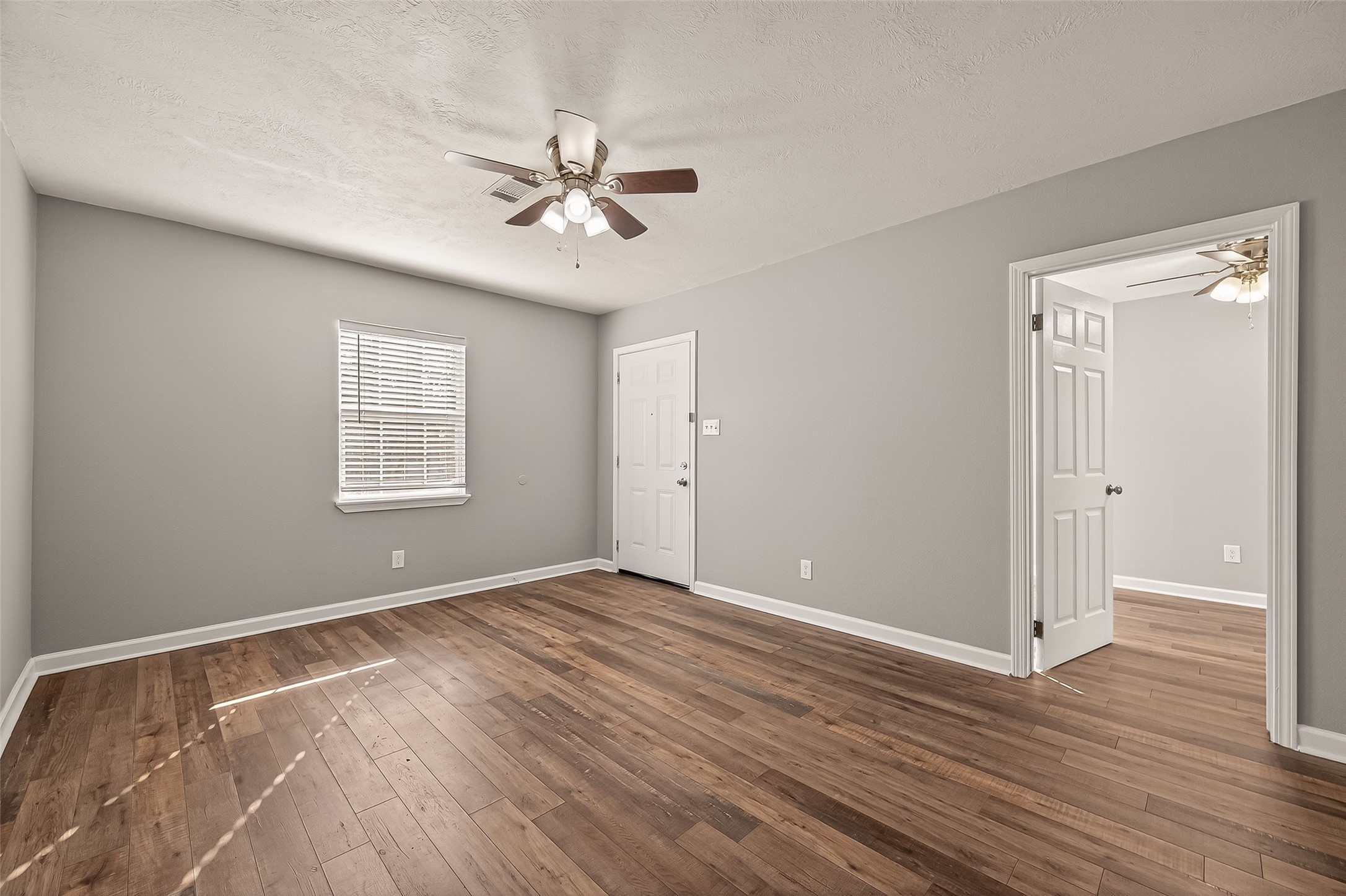 6615 Kernel Street Houston, TX 77087 - Photo 2 of 20 a view of an empty room with wooden floor and a window