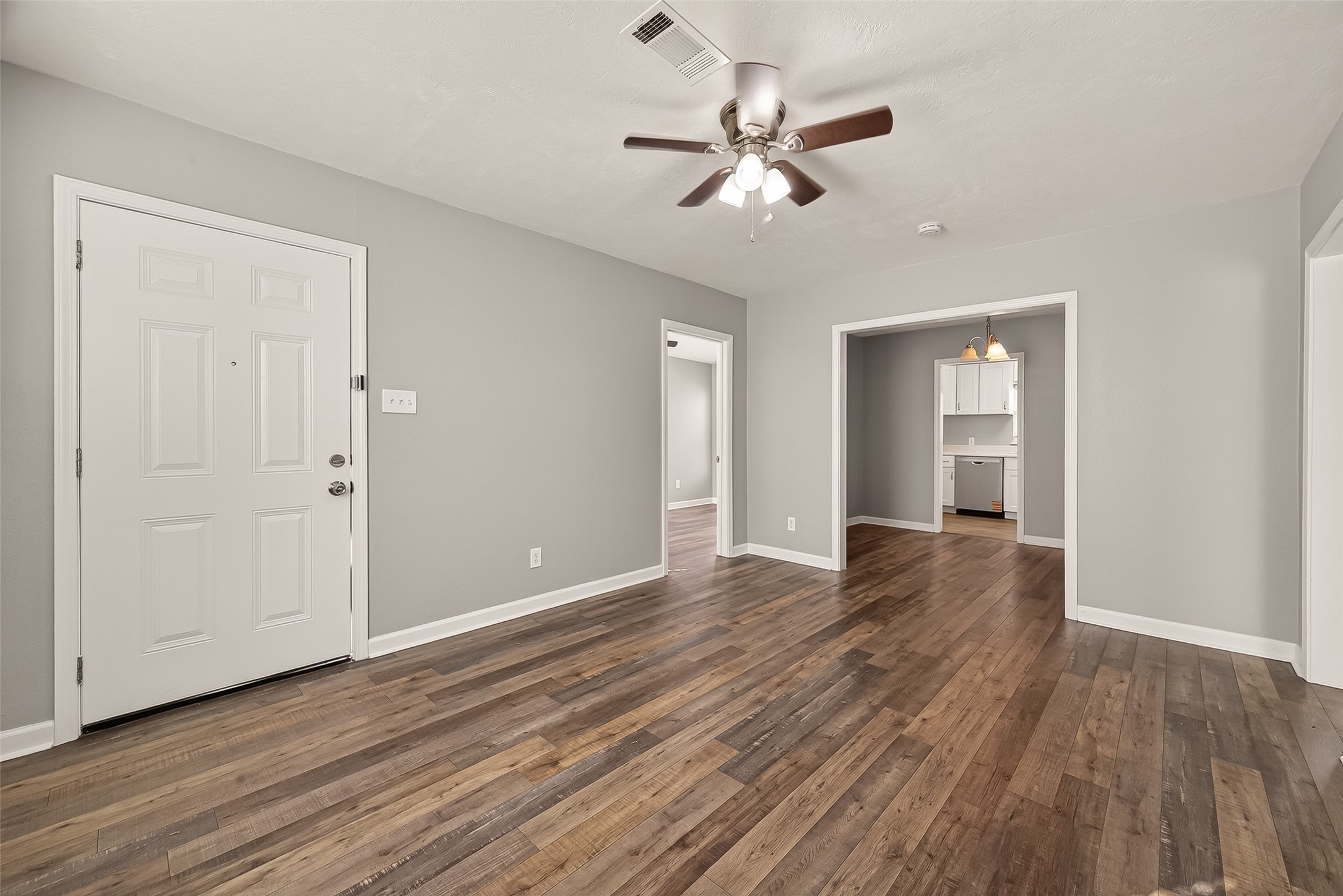 6615 Kernel Street Houston, TX 77087 - Photo 3 of 20 a view of an empty room with wooden floor and a ceiling fan