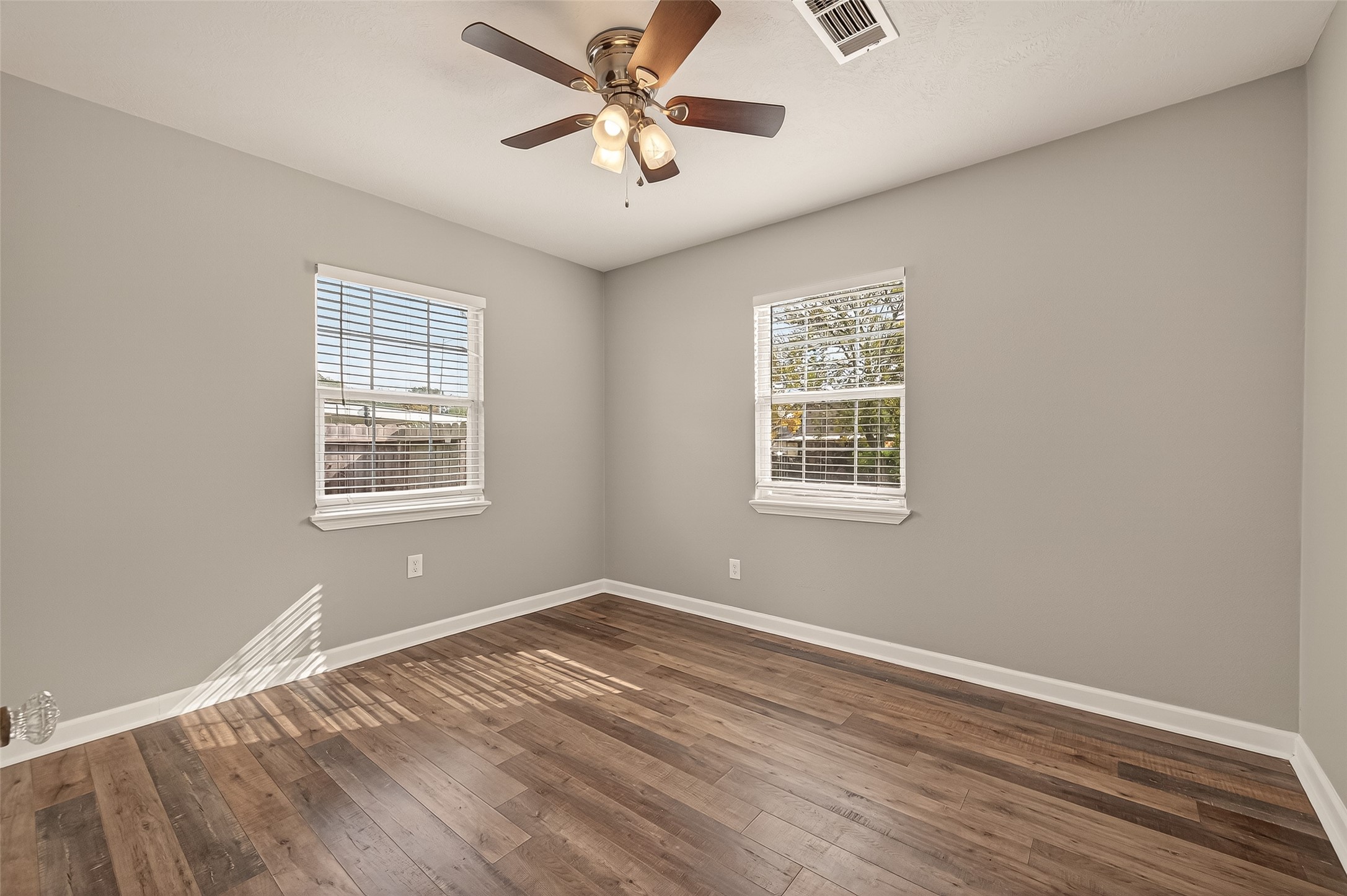 6615 Kernel Street Houston, TX 77087 - Photo 7 of 20 a view of a big room with wooden floor and windows in a room