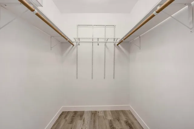 a view of walk in closet with empty racks