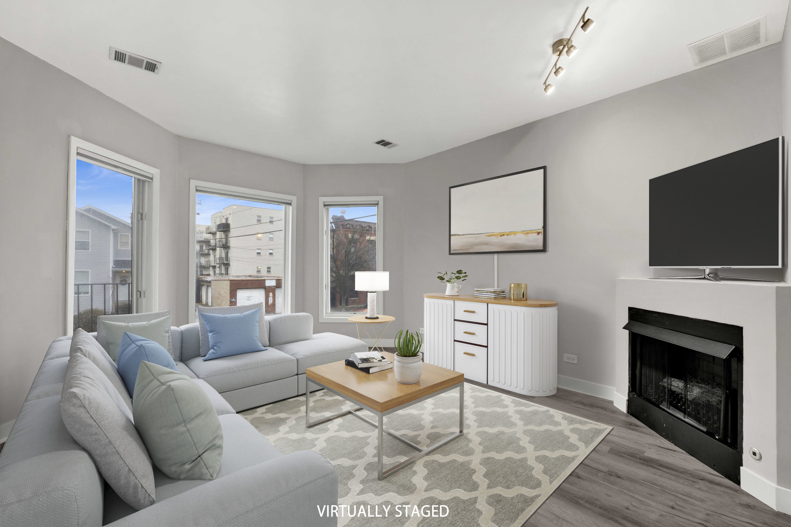 2413 West Polk Street, Unit 2 Chicago, IL 60612 - Photo 2 of 16 a living room with furniture a fireplace and a flat screen tv