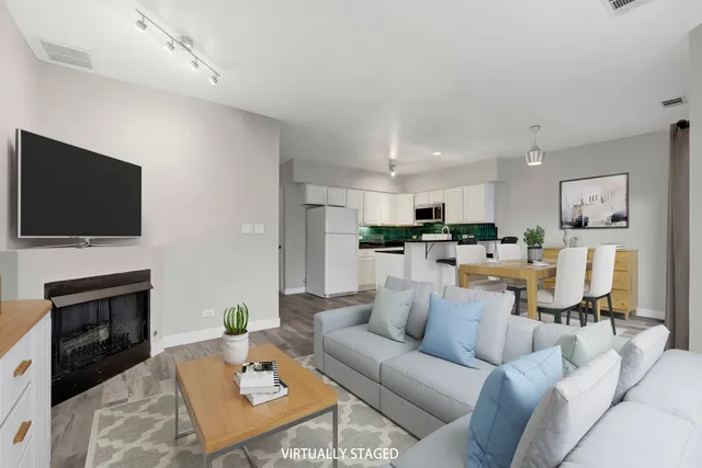 a living room with furniture a flat screen tv and a fireplace