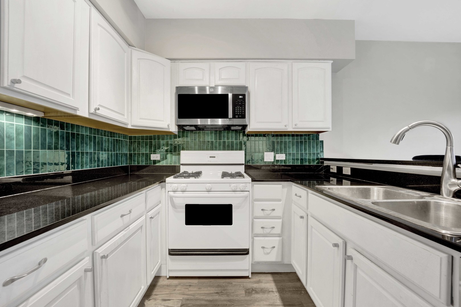 2413 West Polk Street, Unit 2 Chicago, IL 60612 - Photo 6 of 16 a kitchen with white cabinets and white appliances