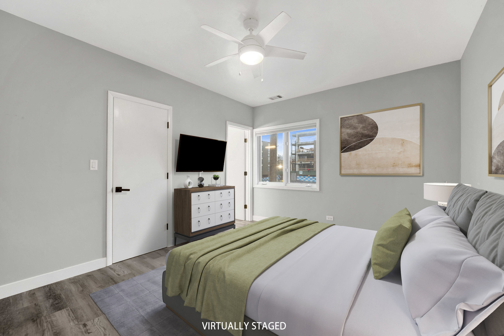 2413 West Polk Street, Unit 2 Chicago, IL 60612 - Photo 7 of 16 a bedroom with a large bed a flat screen tv and a chandelier