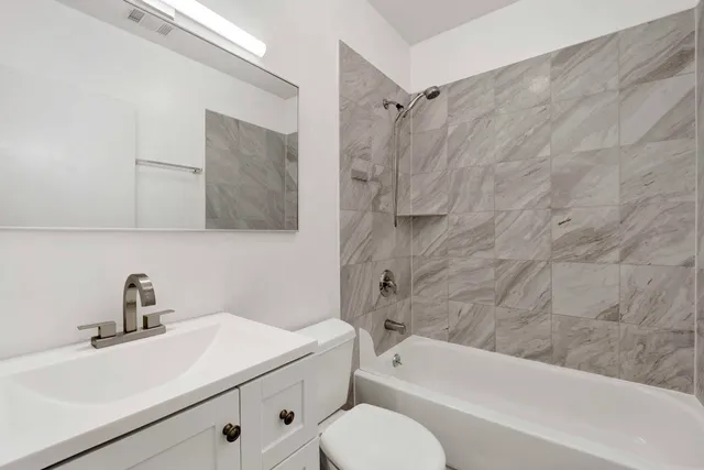 a bathroom with a sink toilet and shower