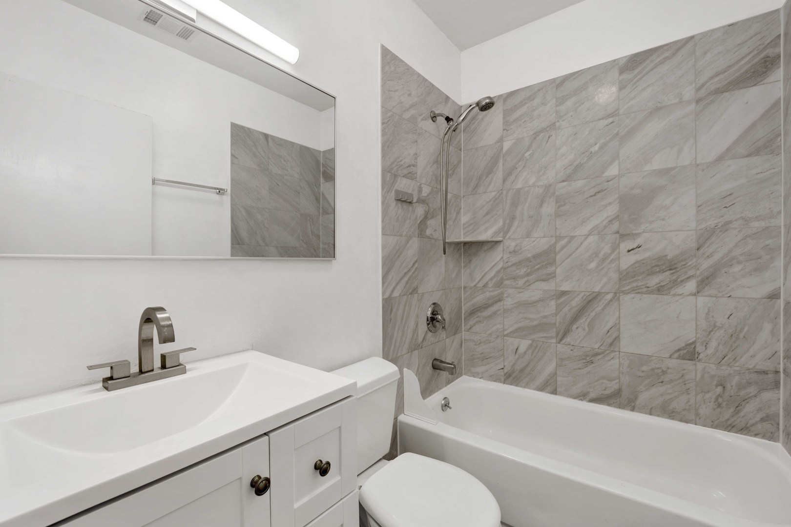 2413 West Polk Street, Unit 2 Chicago, IL 60612 - Photo 8 of 16 a bathroom with a sink toilet and shower