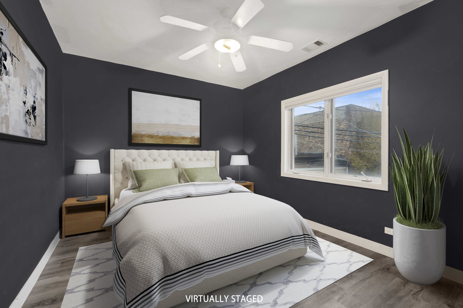 2413 West Polk Street, Unit 2 Chicago, IL 60612 - Photo 9 of 16 a bedroom with a large bed and a potted plant